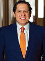 headshot of steve benesh who is wearing a light blue tie, white 
shirt, and dark gray suit